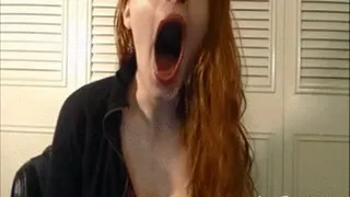 Redhead yawns in sexy dress