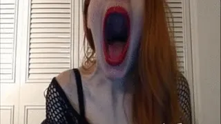 Yawning in fishnet shirt and red lips