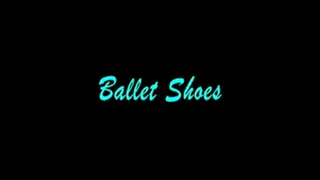 Mistress Isadora puts on her ballet slippers and does a warm up. She points and flexes her toes, goes up onto the balls of her feet. All in her pink ballet slippers