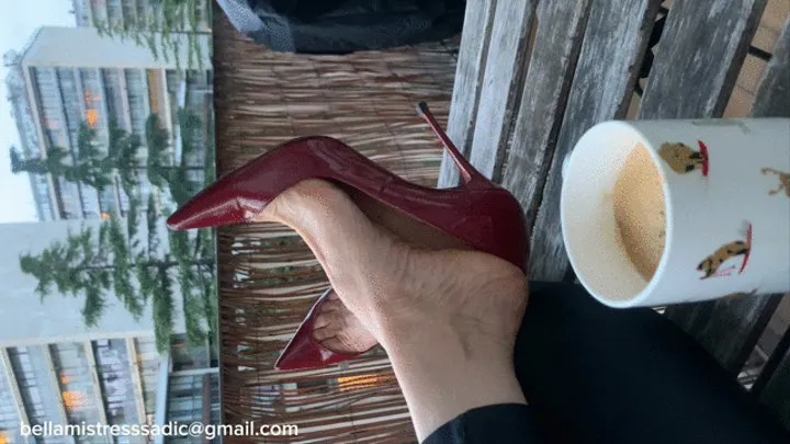 Louboutins on the balcony with large nails and arched soles