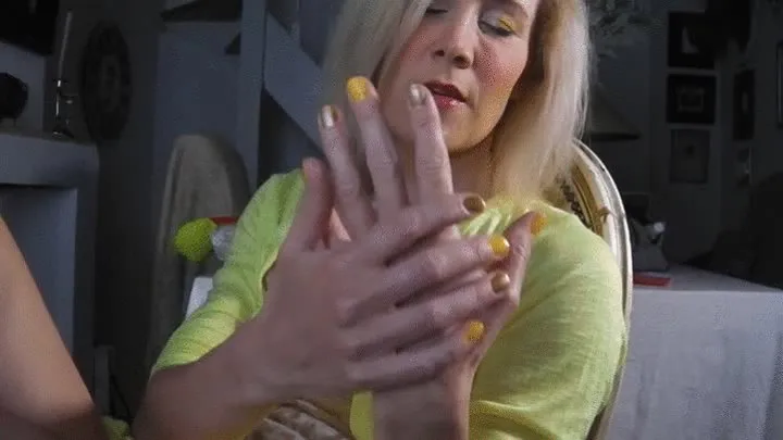 Hand tease with yellow and golden nails