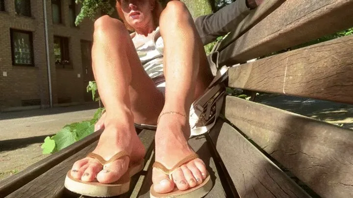 Flip flops and ankle chain on a bench