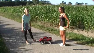 two girls crush a big toycar