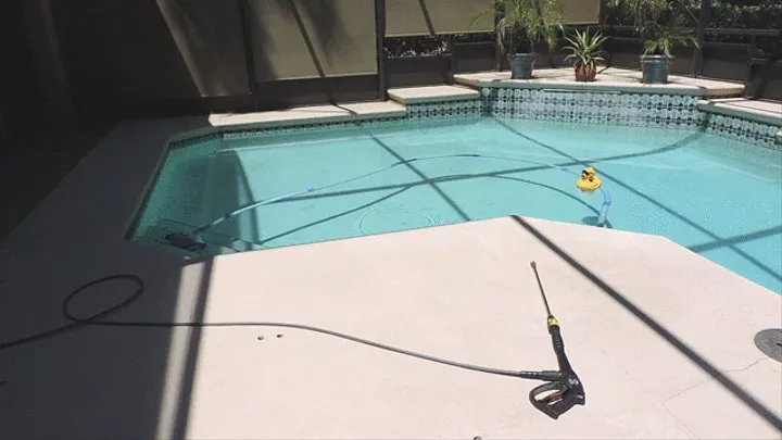 Powerwashing my pool wearing Vintage jeans and white shirt