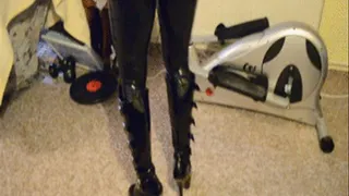 Hot Girl doing Sports in full Latex, Corset and 6 inch Boots on the Hometrainer.