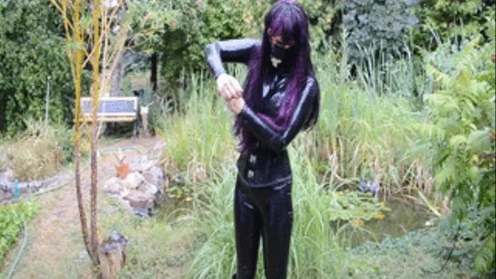 Sexy Girl in Latex catsuit and extreme high heels boots apple trampling in garden, later putting of boots