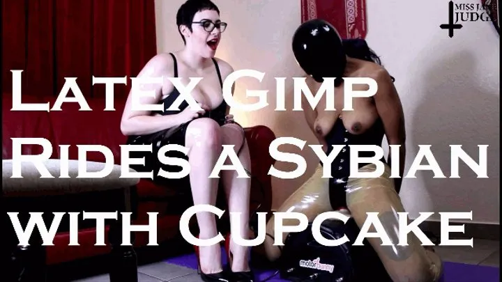 Latex Gimp Rides a Sybian with Cupcake