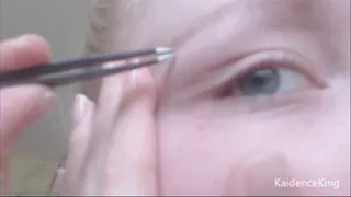 Close-up eyebrow plucking