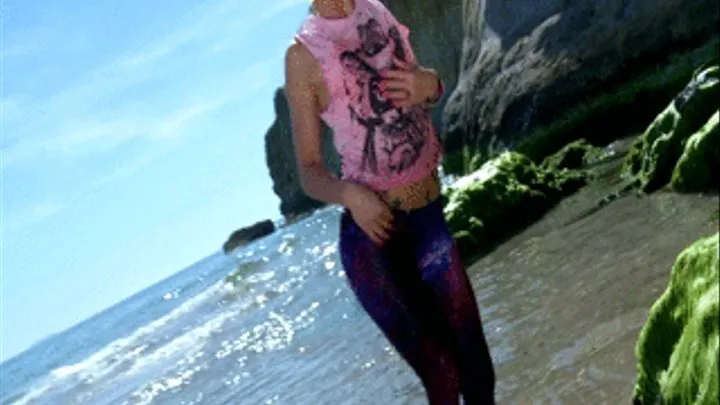 Skinny blonde girl teasing with leggings at the beach