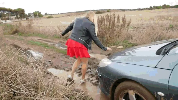 Dirty and wet, she walked along a deserted road.