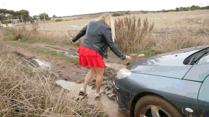 Dirty and wet, she walked along a deserted road.