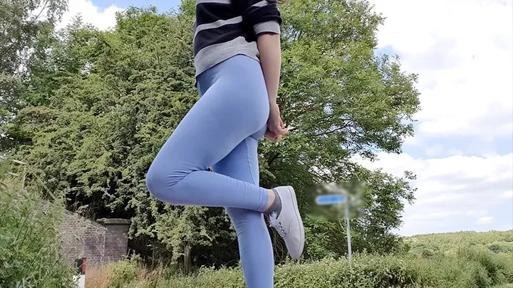 Blue leggings wetting by the road peeing