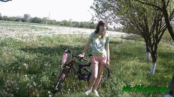 Peeing on her bicycle