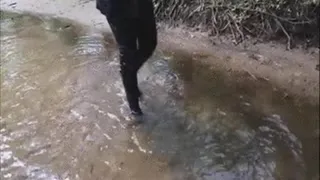 Black gumboots in the water