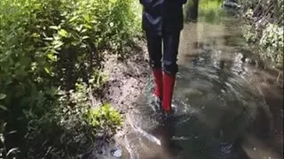 Red gumboots in the river
