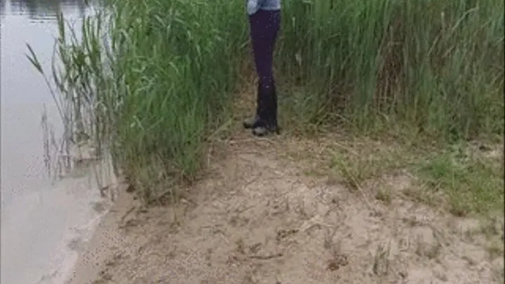 Woman in boots in the lake