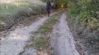 Red wellington boots and a forest path