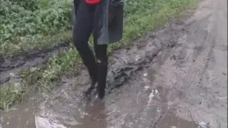 Rubber boots in a puddle