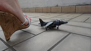 Giantess crushing model airplane outside with wedges and red long toenails