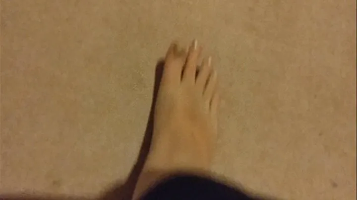 Rubbing foot and scratching toenails on low carpet