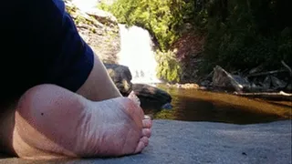 Sole infront of waterfall