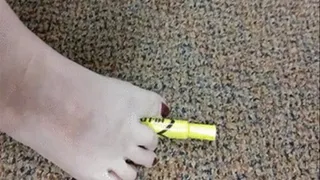 Office picking up and playing with highlighter with toes