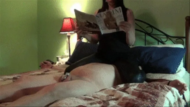 Ignoring Facesat Slave While Reading Magazine