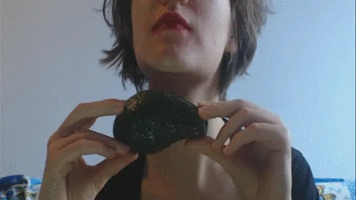 Eating tasty good avocado in red lipstick by fingers