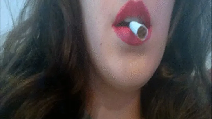 Sexy Brunette with Red Lips and Red Nails Smoking