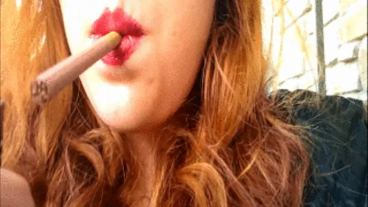 Redhead with Bright Red Lips Smoking a Red Cigarette