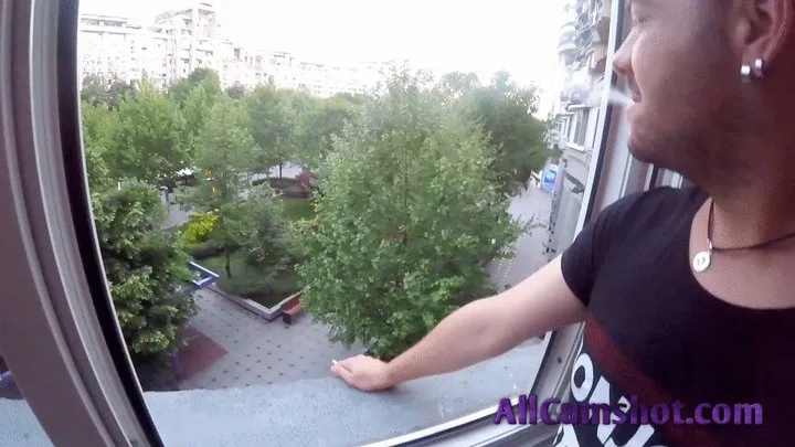 He smokes and relaxes on the balcony while she on her knees suck his dick