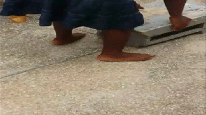 Shomuquaye Oblayo's Ebony Soles Crossed at Ankles