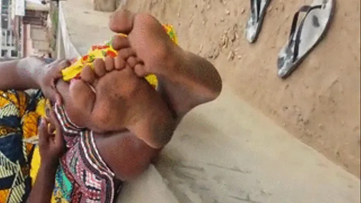 Ghana Woman Crosses Dirty, Wrinkled Ebony Soles at Ankles