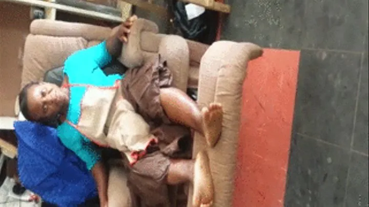 Mango Seller Sits on Lazy Boy Chair and Crosses Ebony Soles