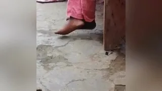Ebony Feet Crossed at Market