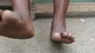 Abrewaa Madam Sitting Down with Feet Moving Up & Down with Soles Shown