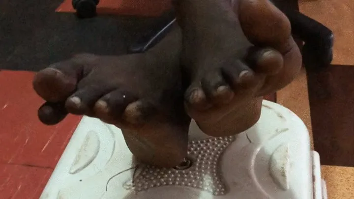 Skinny Dark Skinned Chick's Soles Crossed On Stool