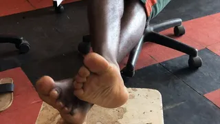 Sak Boy Abre's Soles Crossed at Ankles On Stool