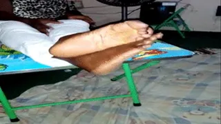 Akweley's Soles Crossed at Ankles On Table