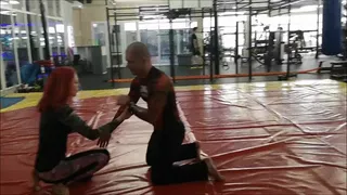 Mixed wrestling in rushguard in public fitness center