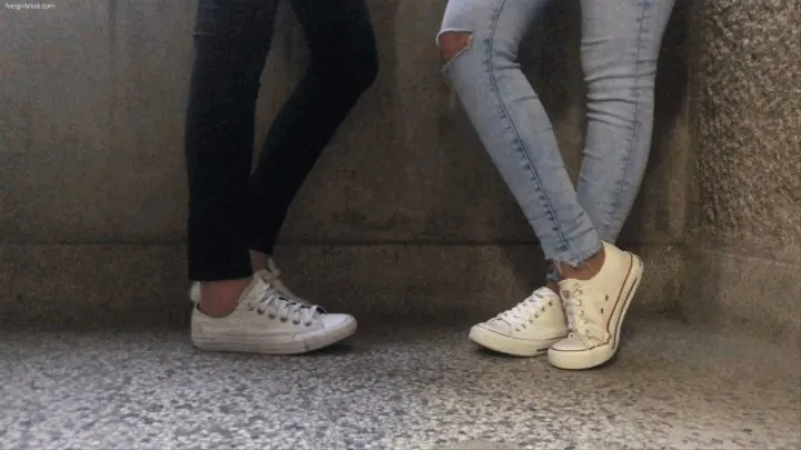 TWO PAIR OF SMELLY CONVERSE SNEAKERS ON A BALCONY