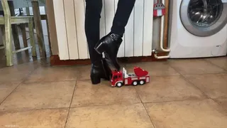 TOY TRUCK CRUSHED UNDER HER BOOTS