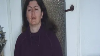 Moved woman blows nose