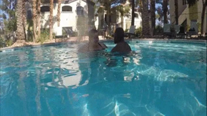 Tony lifting and carrying Monika in the pool