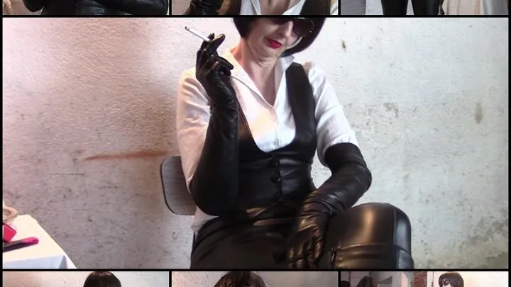 Mistress Angela smokes a cigarette in leather leggings and long gloves