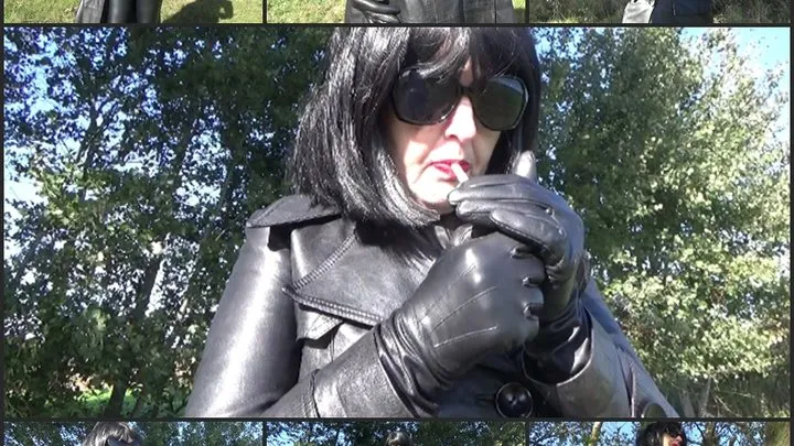 Mistress Angela smokes in a double-breasted leather coat