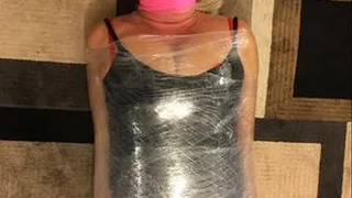 MAGICIANS ASSISTANT GETS SHRINK WRAPPED INTO A NEW TRICK. PLASTIC FETISH