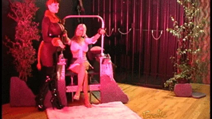 Luscious domina has fun with a blonde hussy and performs a striptease