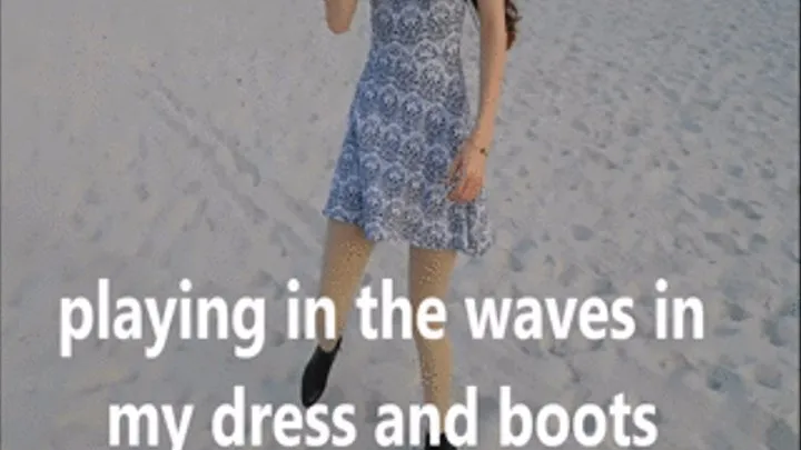 Playing in the waves wearing a dress and boots