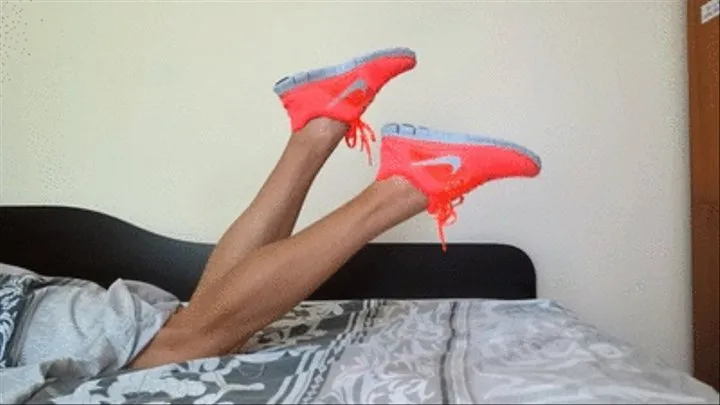 Lying on the bed and shoe play with my new nike pink free run sneakers while flexing my calves